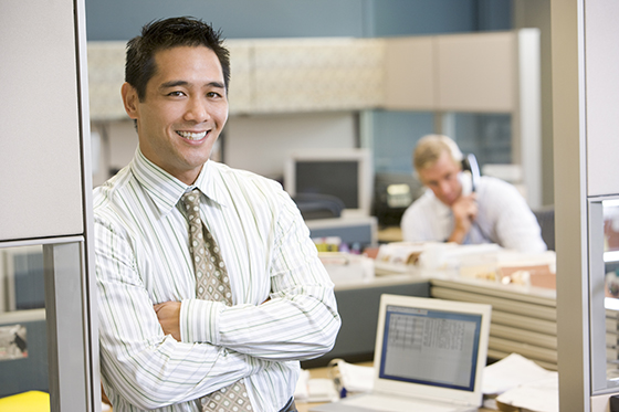 Businessman standing in cubicle