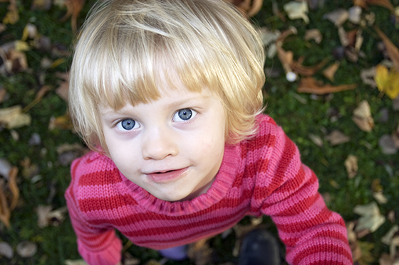Young child looking up at camera
